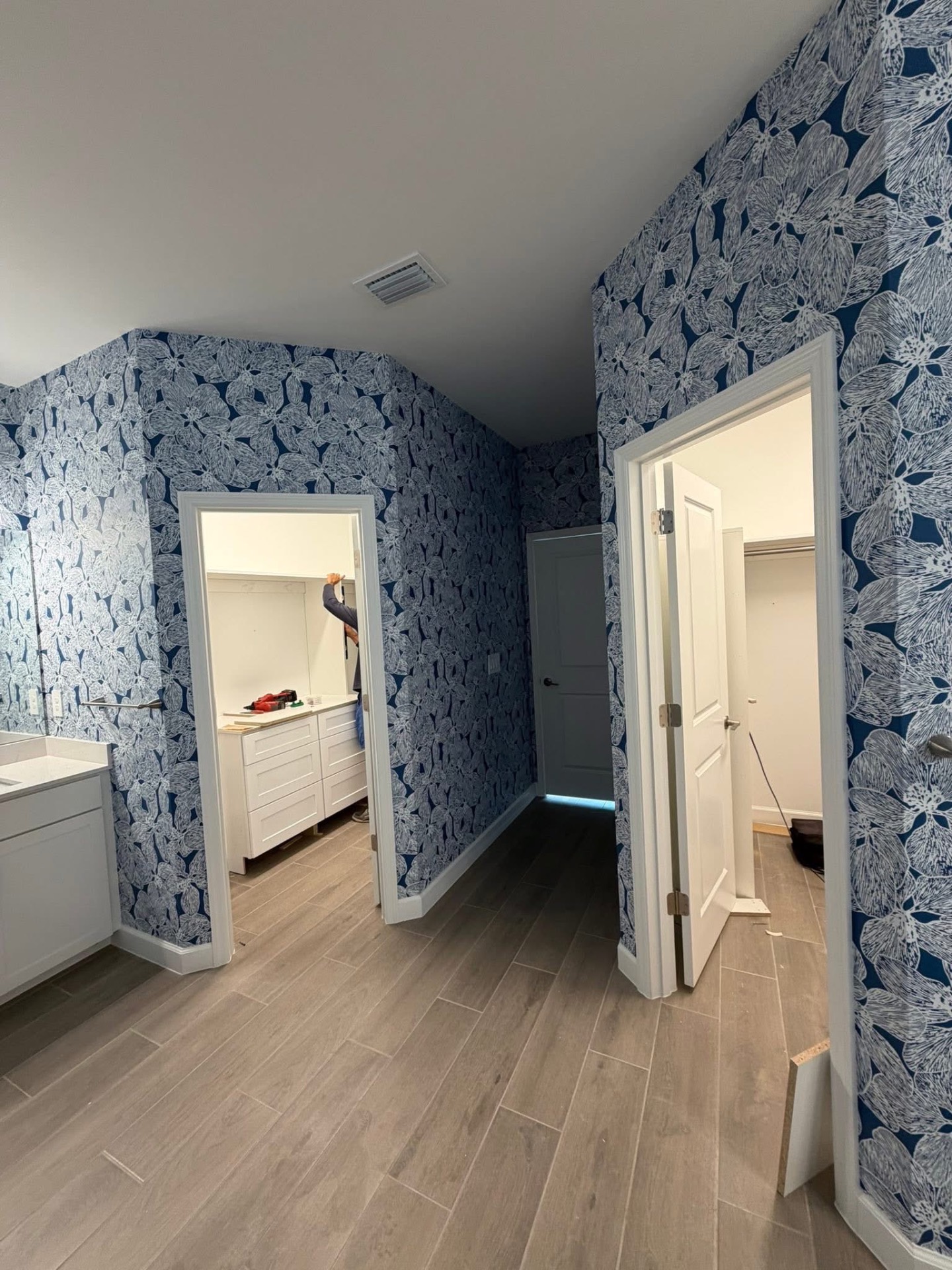 Wide view of blue botanical bath and dressing area